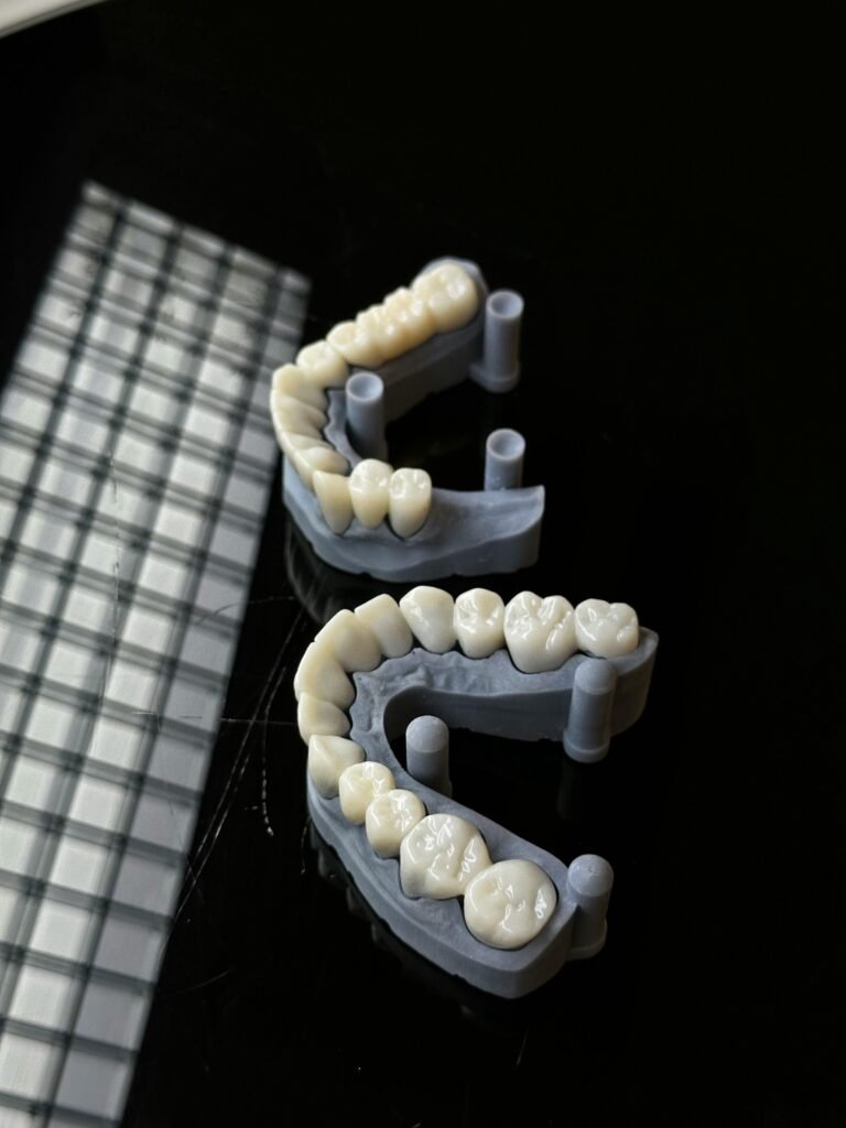 High-quality 3D printed dental molds displayed on a reflective dark background, showcasing dental technology.